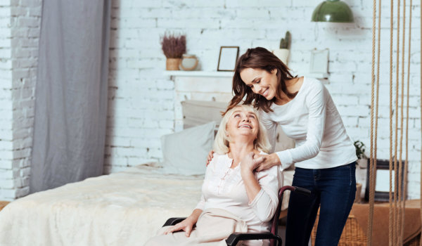elderly woman and caregiver looking to each other